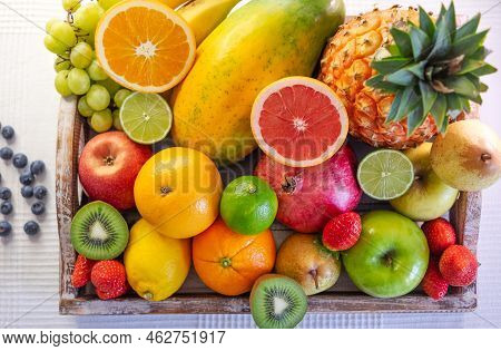 Above View Of Wooden Basket Full Of Fresh Fruits And Colors. Healthy Lifestyle And Eating