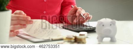 Close-up Of Accountant Count On Black Calculator, Cash Coin On Office Workplace. Calculation Of Inco