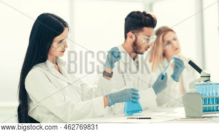 Close Up.modern Woman Sitting With Colleagues At The Laboratory