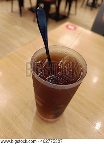 Sweet Iced Tea Served On A Wooden Table In A Restaurant