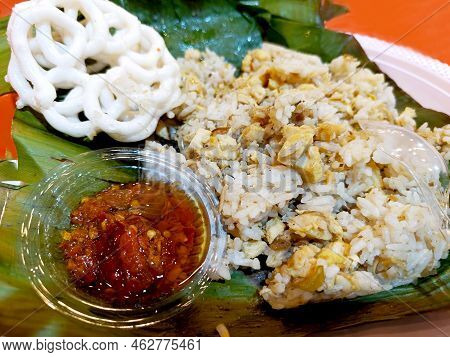 Indonesian Chicken Grilled Rice Served On Banana Leaf With Chili Sauce And Crackers