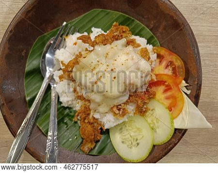 Breaded Fried Chicken Rice With Melted Mozzarella Cheese On Top Served On A Wooden Plate