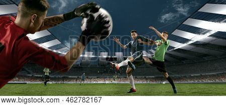 Scoring Chance. Closeup Of Football Goalkeeper In Gates Jumping To Catching Flying Ball During Socce