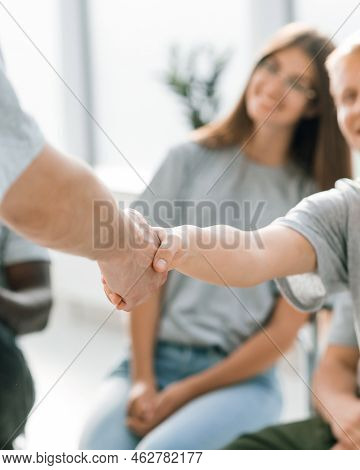 Young Employees Greeting Each Other With A Handshake