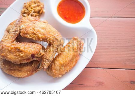 Thai Fried Chicken Wings Served With Sweet Dip On Wood Tabel