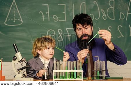 Bearded Man Teacher With Little Boy. Father And Son Child At School. Laboratory Test Tubes And Flask