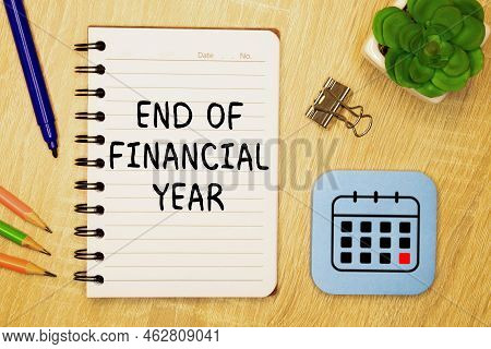 Finance And Economics Concept. The Man Is Holding A Pen And A Notebook With The Inscription - End Of