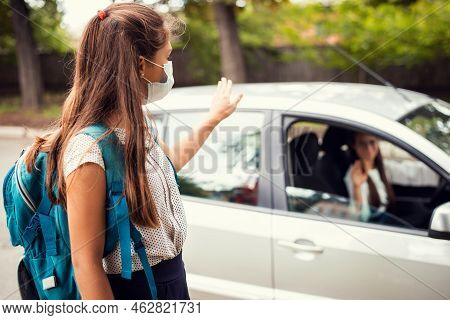 Mother In Car, Dropping Off Her Daughter To The School And Wishing Her A Good Day. Back To School, M