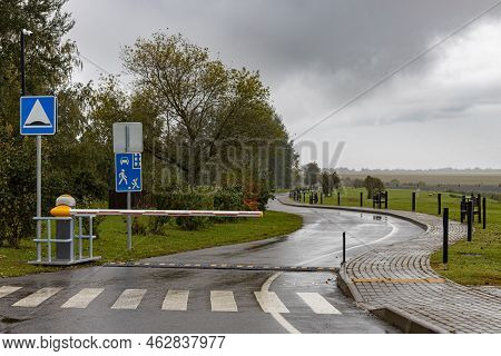 Lowered Barrier At The Checkpoint On The Road. Barrier On The Road