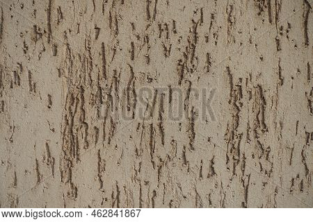 Closeup Of Beige Wall With Stucco Worm Finish