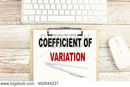Coefficient Of Variation Text On Clipboard With Keyboard On Wooden Background