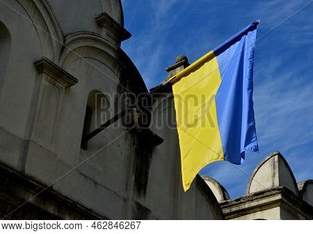 Blue And Yellow Flags Hang From The Occupied Houses, Someone Hung A Flag Through The Opening In The 