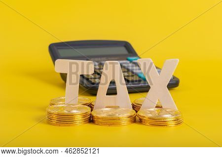 Tax Btc Cryptocurrency With Tax Wording On Bitcoin And Caculator On Stock Graph Yellow Background