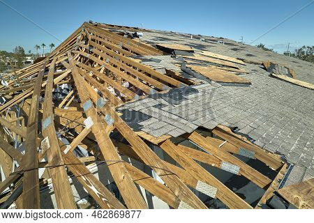 Hurricane Ian Destroyed House Roof In Florida Residential Area. Natural Disaster And Its Consequence