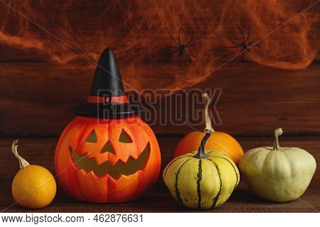 Halloween Postcard. Jack-o-latern With Decorative Pumpkins Against The Background Of Cobweb With Two
