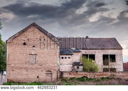 Old Windows And A Crumbling Facade On An Abandoned Residential Building Of A Farm In Ruma, Vojvodina
