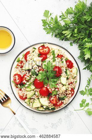 Bulgur Tabbouleh Salad With Fresh Tomatoes, Cucumbers And Parsley. Traditional Middle Eastern And Ar