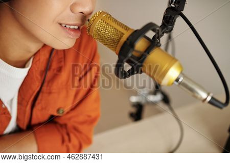Selective Focus Of Modern Young Asian Male Influencer Whispering In Microphone, Creating Asmr Conten