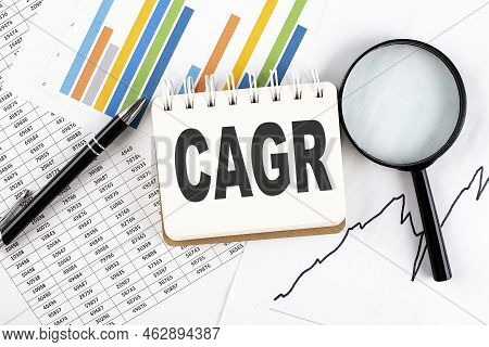 Cagr Text On A Notebook On The Graph Background With Pen And Magnifier