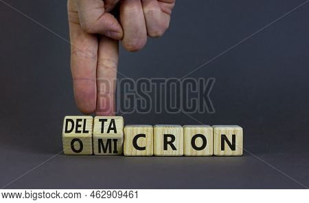 Covid-19 Omicron Or Deltacron Symbol. Doctor Turns Cubes And Changes The Word Omicron To Deltacron. 