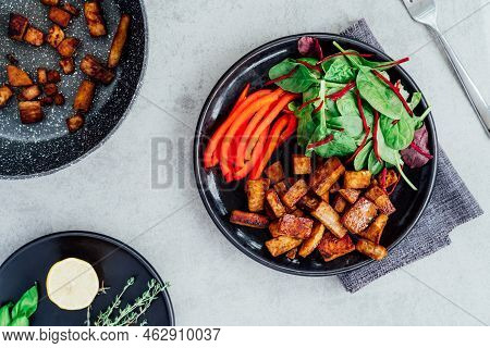 Top View Healthy Green Salad, Sliced Pepper And And Portion Of Roasted Tempeh, Made Of Fermented Soy