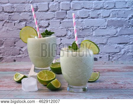 Brazilian Lemonade Made From Condensed Milk And Lime. Pieces Of Fruit, Ice Cubes. Composition On A L