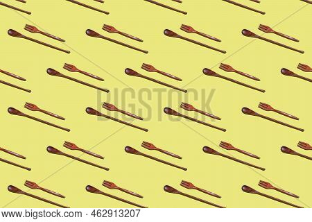 Top View On Many Bamboo Spoons And Forks On A Yellow Background, Eco Tableware, Disposable Cutlery, 