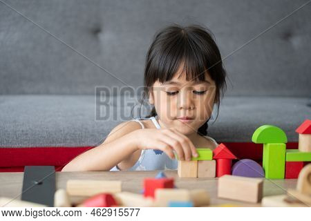 Cute Asian Little Girl Playing With Colorful Toy Blocks, Kids Play With Educational Toys At Kinderga