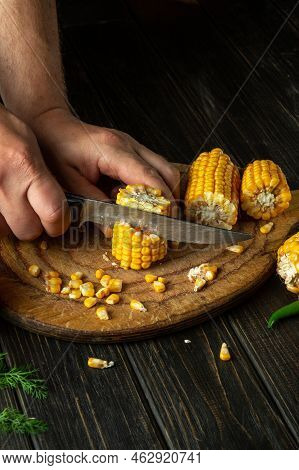 The Chef Cuts Corn With A Knife. Maize Is An Excellent Dietary Breakfast Or Lunch Prepared By The Co