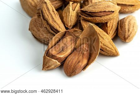 Bunch Of Inshell Almonds. Isolated On A White Background. Selective Focus.
