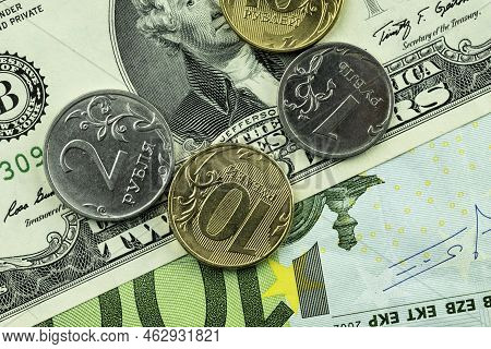 A Coin Of Russia In Denominations Of 1 Ruble, 2 Rubles And 10 Rubles And A Dollar Bill And 100 Euro,