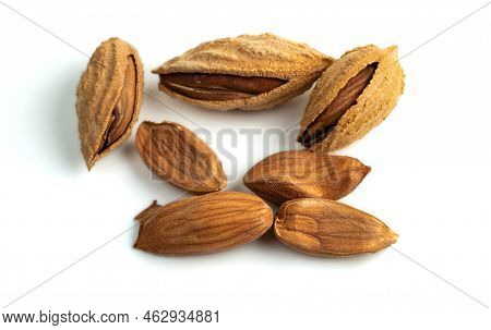 A Bunch Of Selected Dried Inshell Almonds Isolated On White Background. Selective Focus.