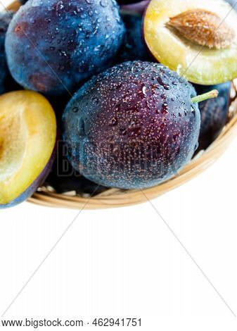 Fresh Plums In Basket On White Background.