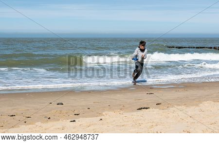 Cadzand, Zeeland - The Netherlands- 04 03 2021- Little Boy With The Waves At The Beach