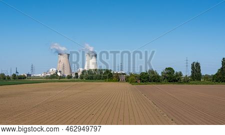 Doel, East - Flanders - Belgium - 06 01 2021 Cooling Towers Of The Nuclear Power Reactors With Agric