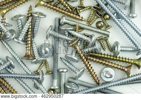 Metal Bolts And Nuts In A Row Background. Chromed Screw Bolts And Nuts Isolated. Steel Bolts And Nut