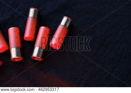 Shotgun Shells On A Black Surface. Ammunition For 12 Gauge Smoothbore Weapons. Hunting Ammunition. D