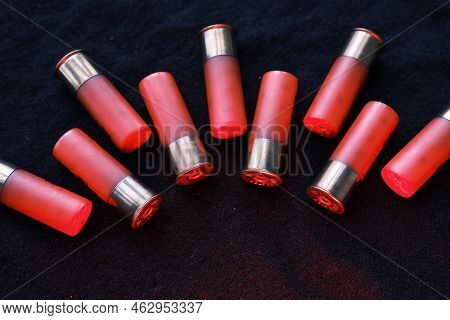 Shotgun Shells On A Black Surface. Ammunition For 12 Gauge Smoothbore Weapons. Hunting Ammunition. D