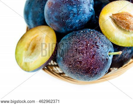 Fresh Plums In Basket On White Background.