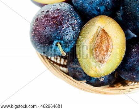 Fresh Plums In Basket On White Background.