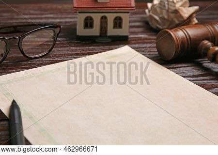 Last Will And Testament Near House Model, Glasses And Gavel On Wooden Table, Closeup