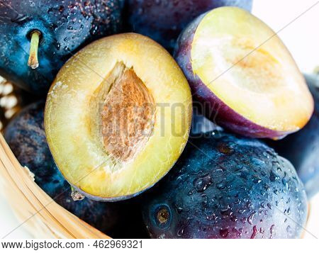 Fresh Plums In Basket On White Background.