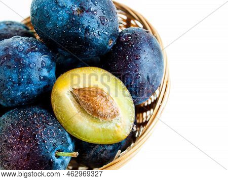 Fresh Plums In Basket On White Background.