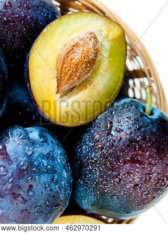 Fresh Plums In Basket On White Background.