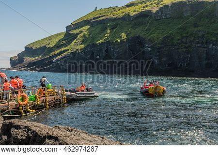 Udo Island, South Korea; June 22, 2022: Unidentified People Waiting As Rubber Dingy Pulls Up To Dock