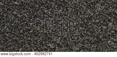 Black Dry Tea Wallpaper. Black Tea Leaves. Close Up, Macro. Top View. Texture. Full Frame. Copy Spac