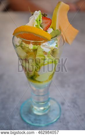 A Sundae With A Variety Of Fruits On A Table.