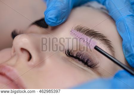 Beautician Tattooing Woman's Eyebrows Using Special Equipment During Process Of Permanent Make-up.