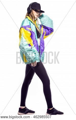 Ful Length Portrait Of Winsome Sportwoman In Fitness Outfit And Baseball Cap With Wireless Headphone