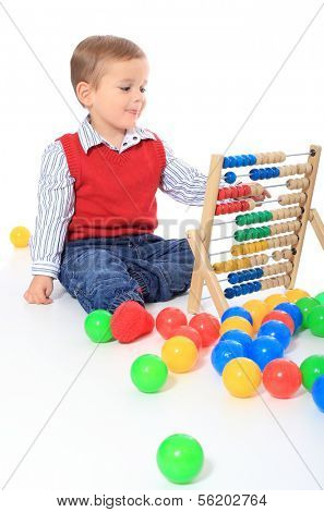 Cute caucasian toddler playing with sliderule. All isolated on white background. Foreground in very light grey.